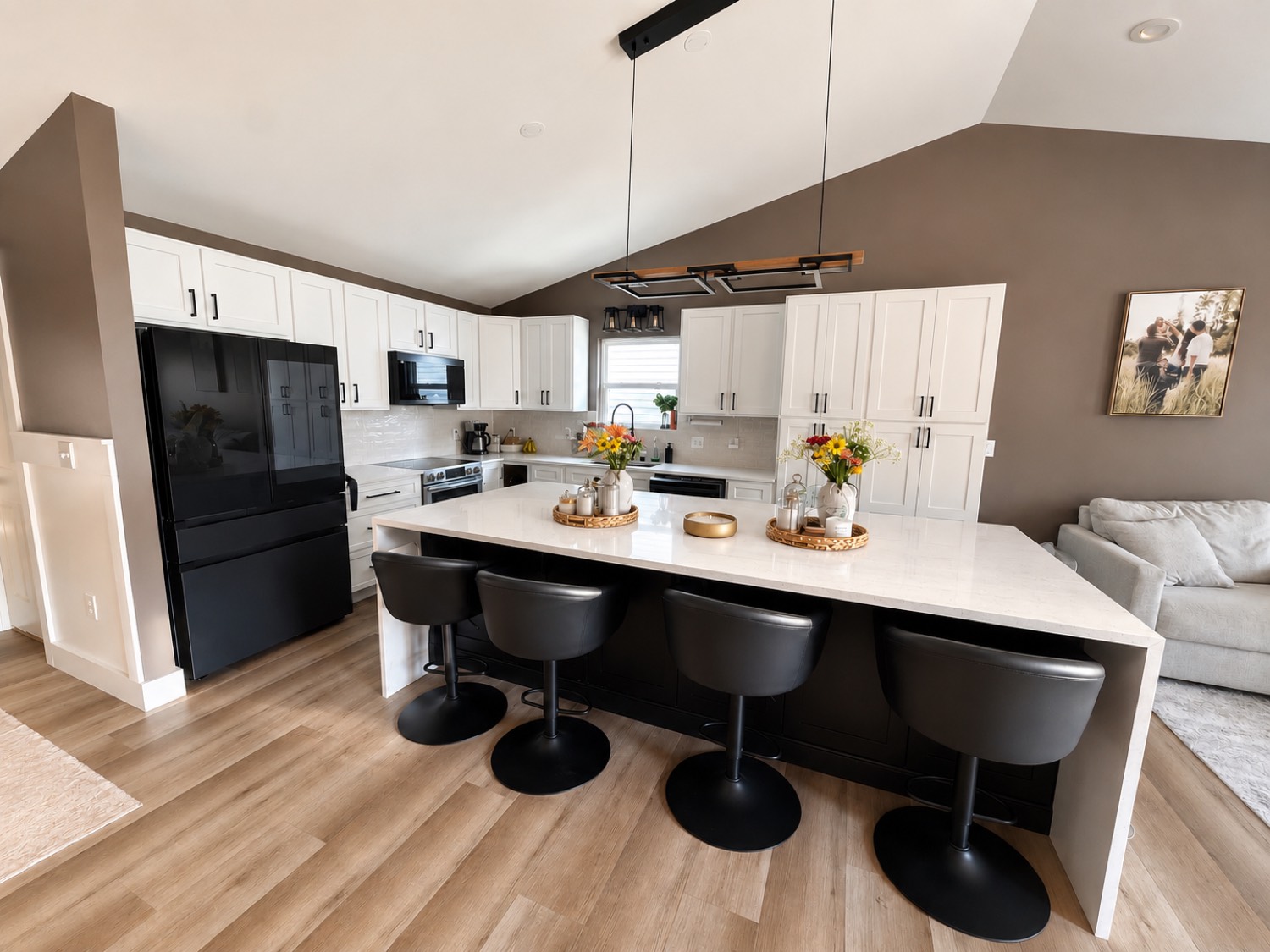 Remodeled kitchen with island and quartz counters