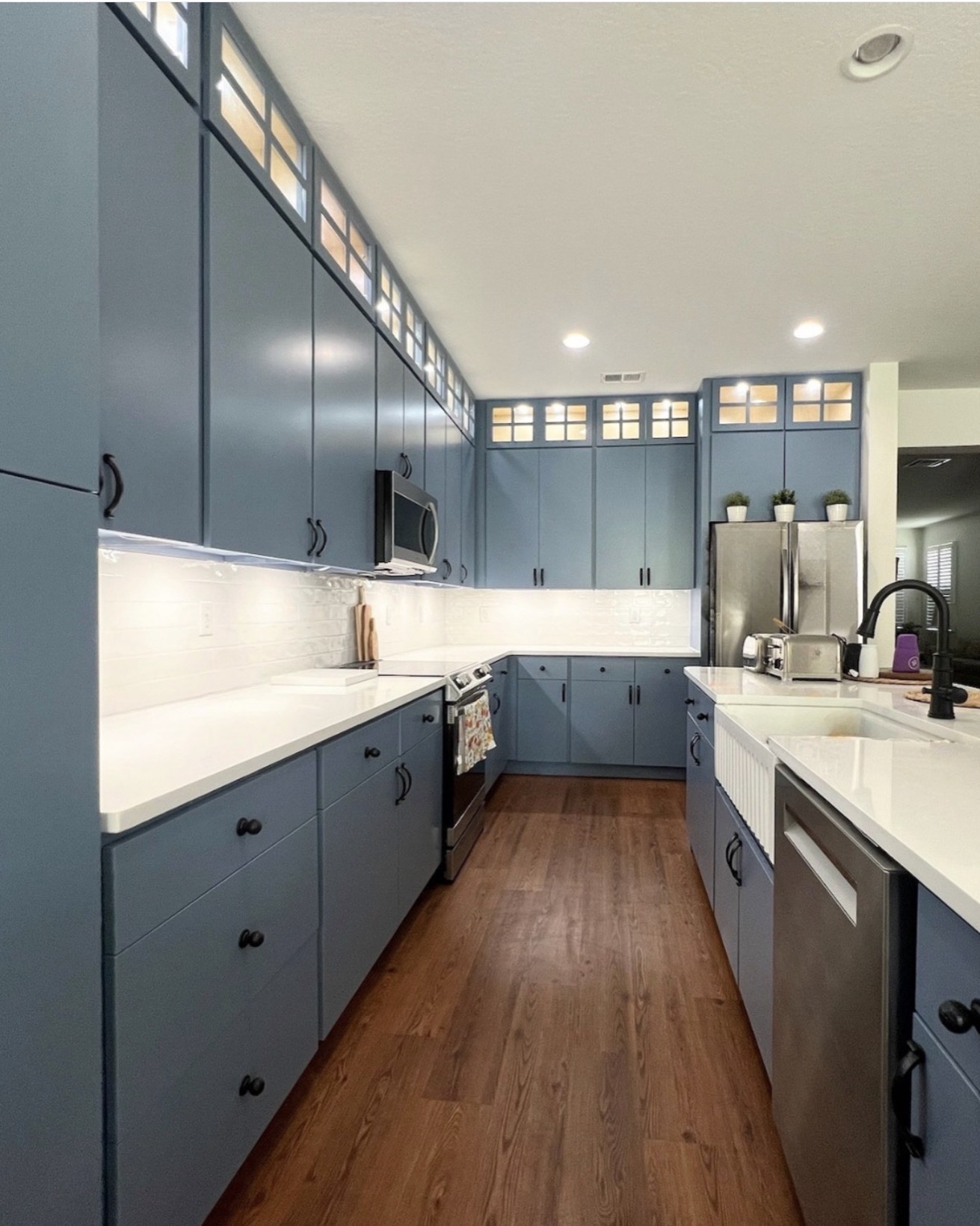 Navy blue kitchen remodel with gold hardware and quartz countertops — St. Louis remodel by Phoenix Construction Group