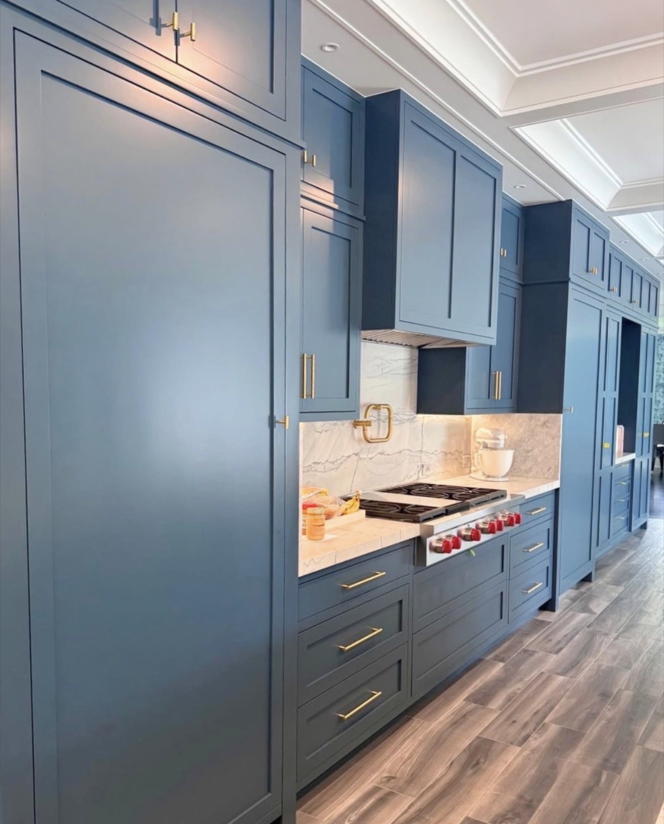 Navy kitchen with floor-to-ceiling cabinetry and marble backsplash — St. Louis remodel by Phoenix Construction Group