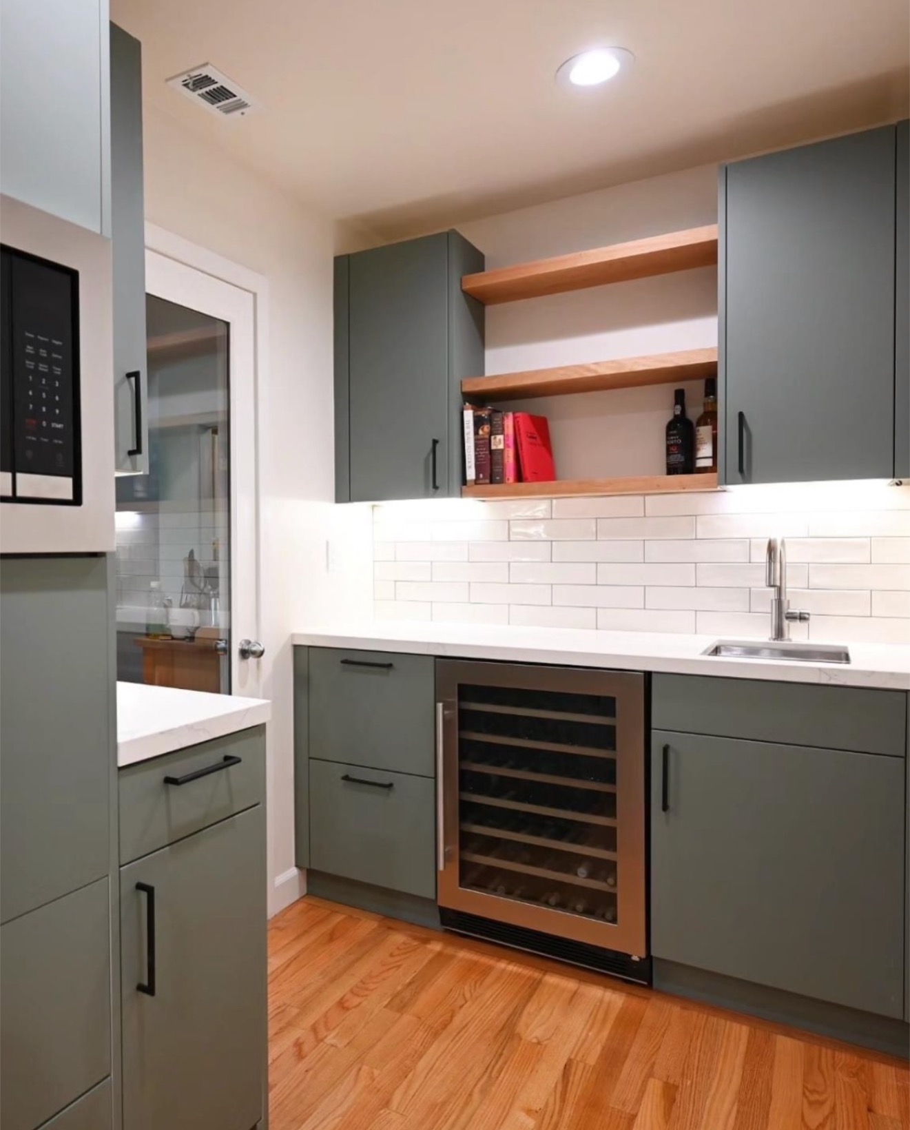 Gray-green kitchen with subway tile backsplash — St. Louis remodel by Phoenix Construction Group