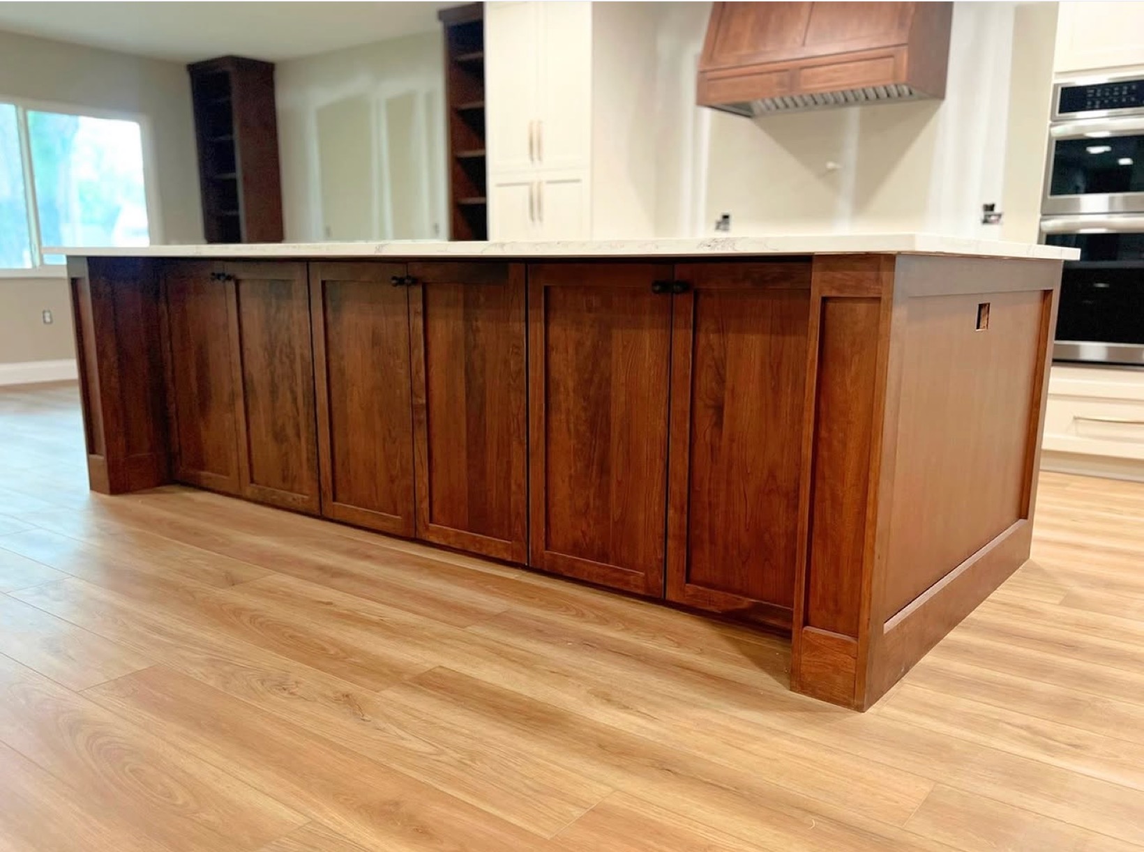 Cherry wood kitchen with center island and hardwood floors — St. Louis remodel by Phoenix Construction Group